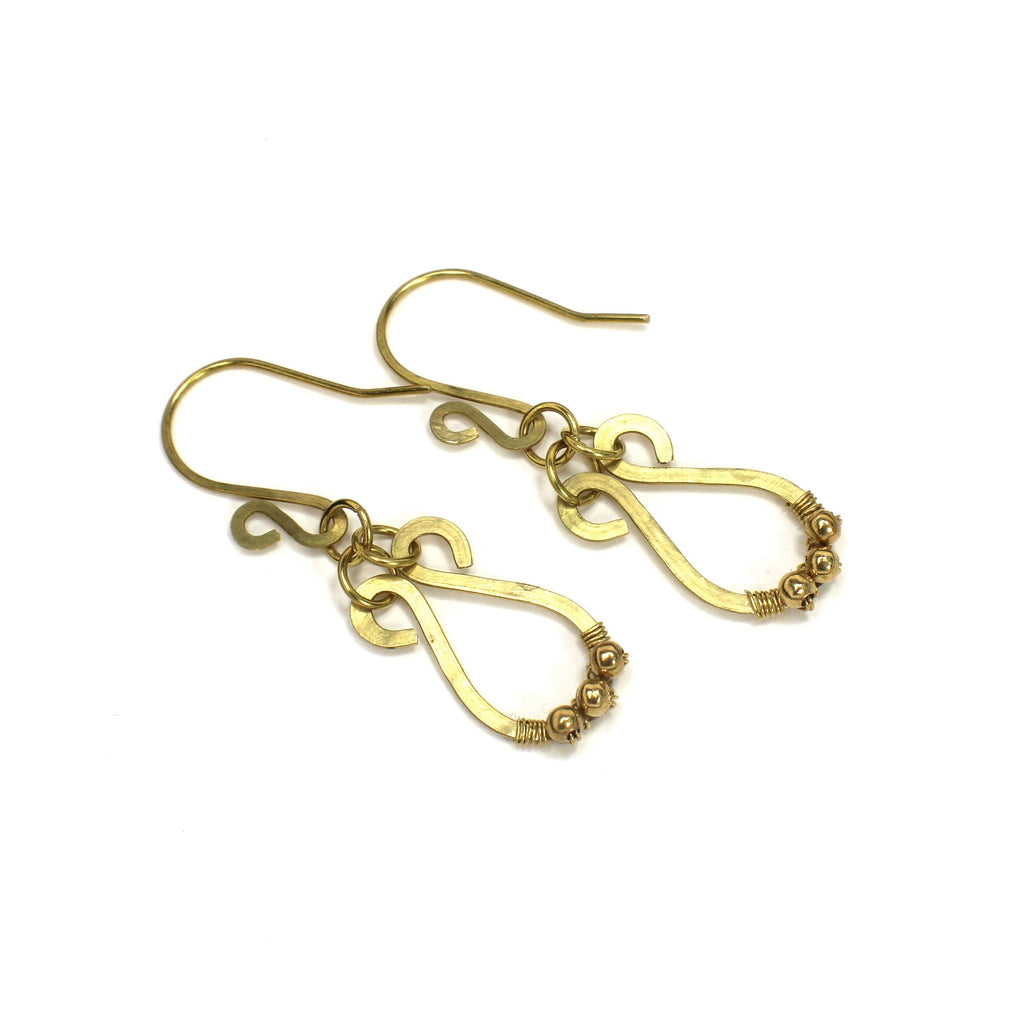 Hammered brass teardrop earrings with small brass bead accents on a white background