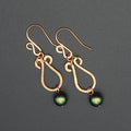 Hammered copper teardrop earrings ending in green glass pearl drops.