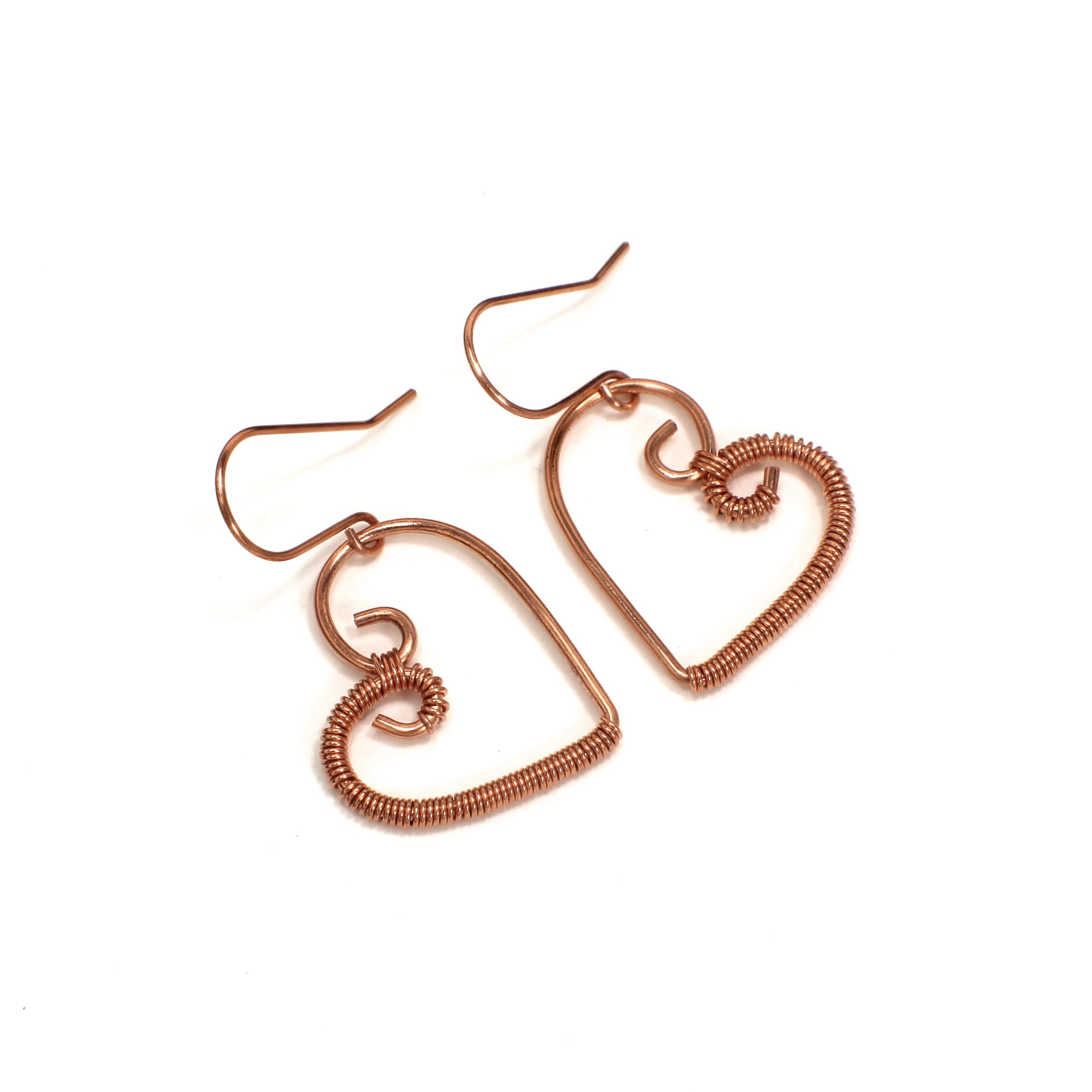 Heart-shaped copper wire earrings on a white background