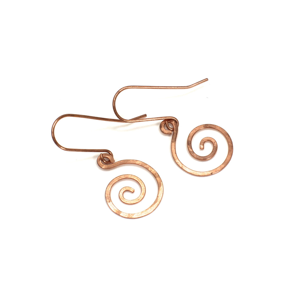 Copper spiral earrings on a white background