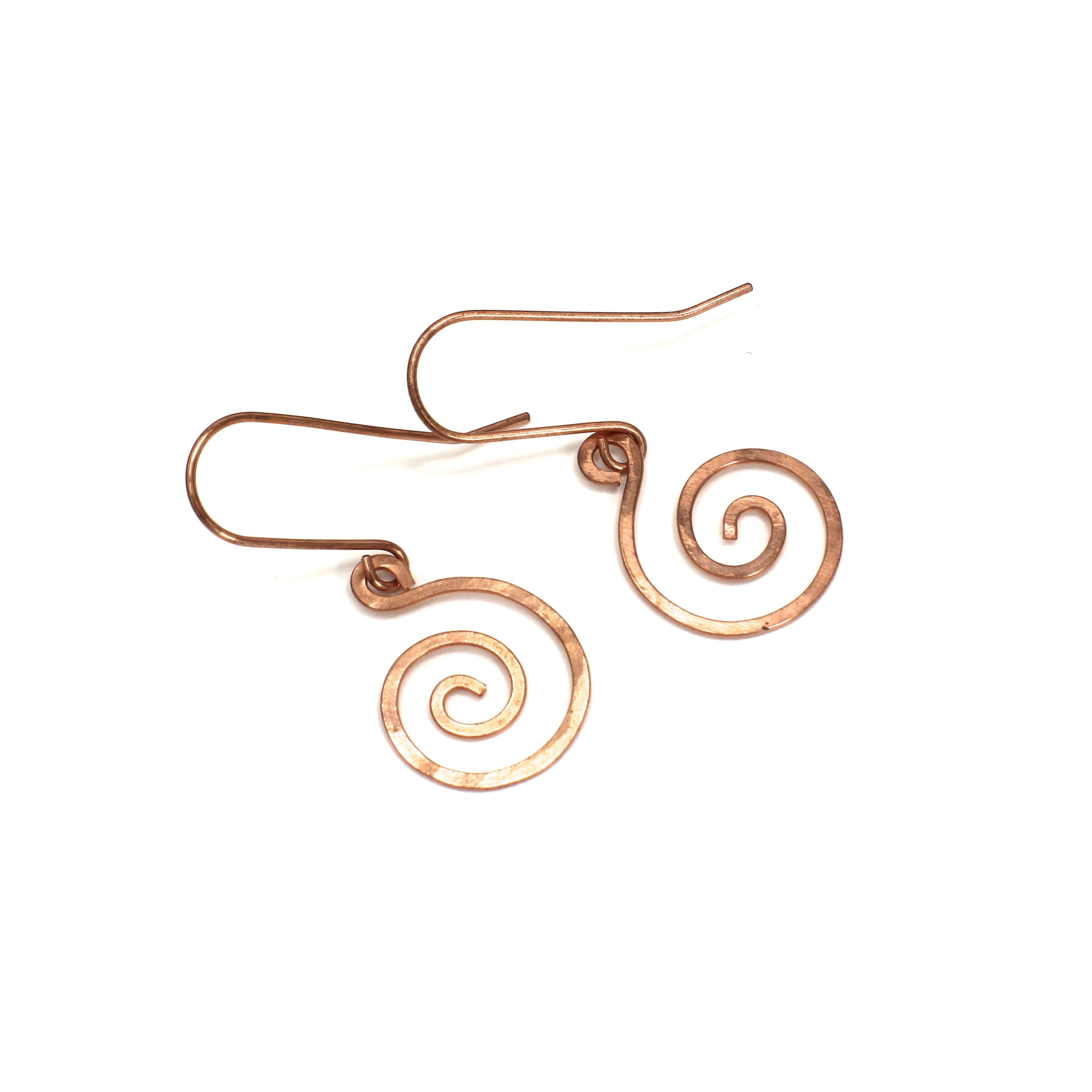 Copper spiral earrings on a white background