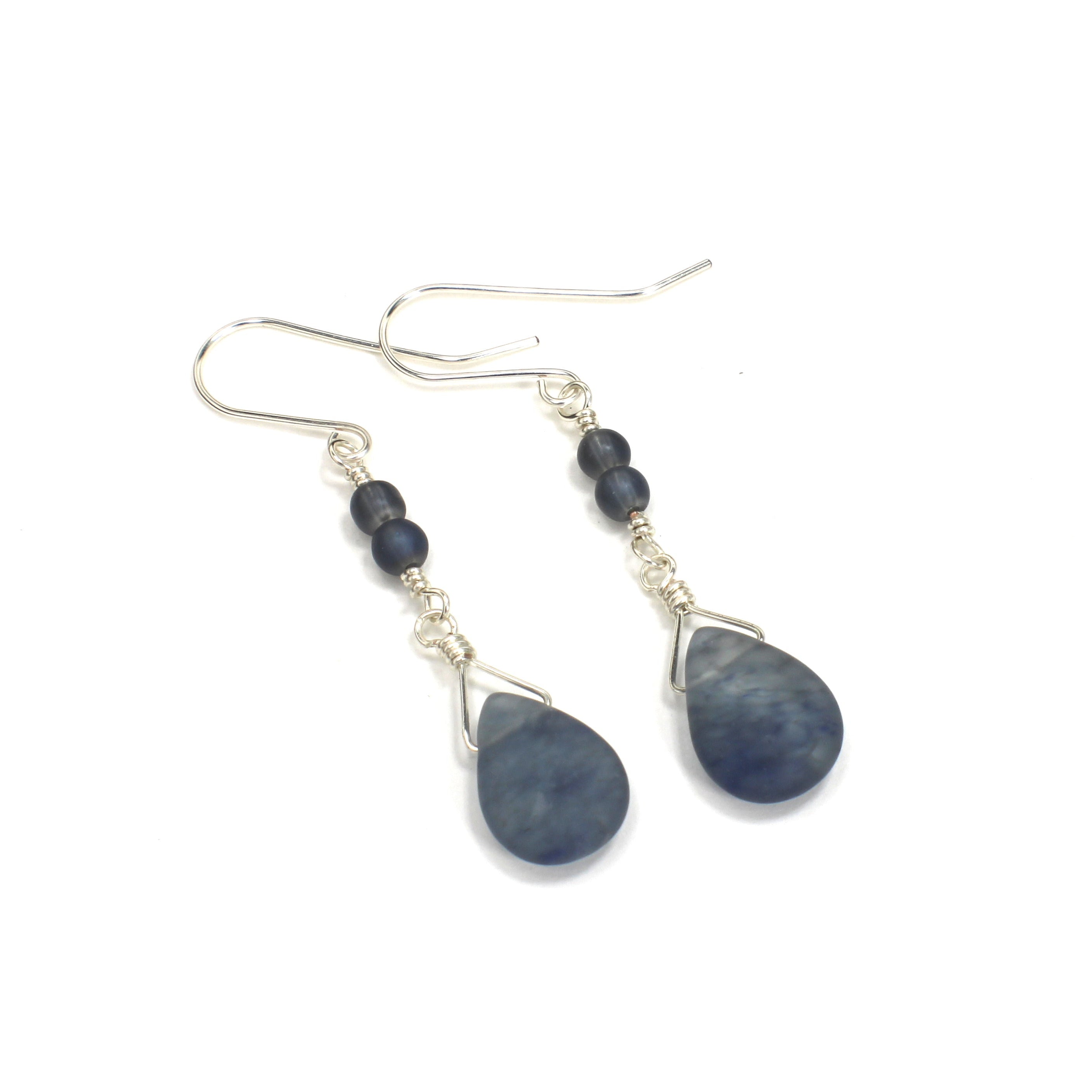 Pair of earrings with teardrop-shaped blue agate stones on a white background